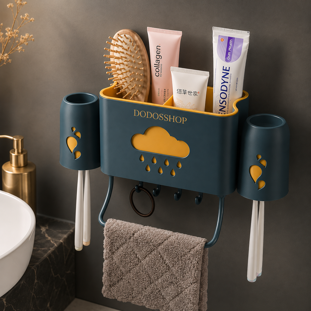 Bathroom Storage Rack
A wall-mounted bathroom organizer in dark teal with mustard yellow accents, holding toothbrushes, a toothbrush holder cup, a hairbrush, and toiletry tubes. A towel hangs from the lower hook, and the organizer is shown against a dark bathroom wall with a sink partially visible.