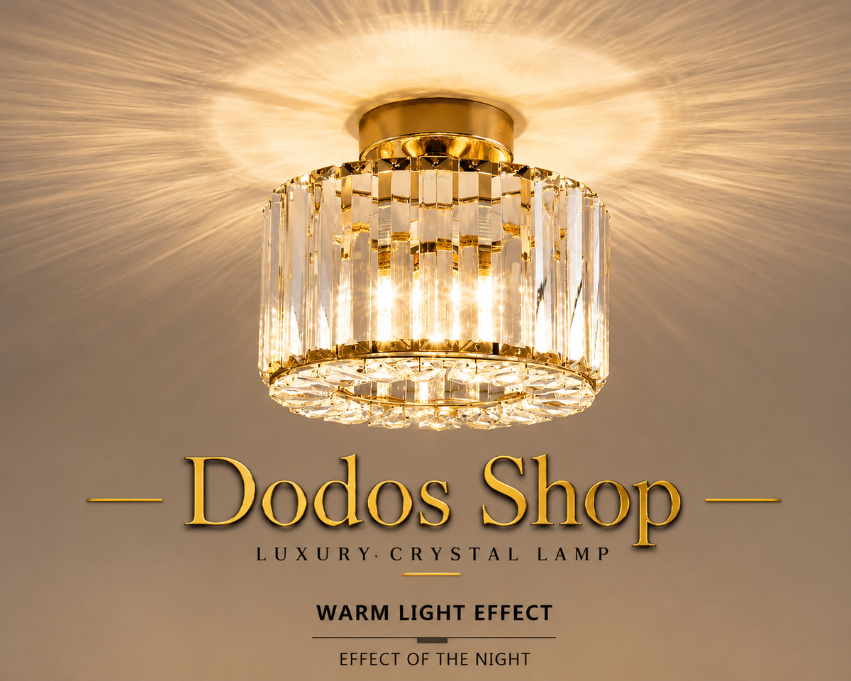 Luxury Crystal Lamp
A cylindrical crystal chandelier with gold trim and clear hanging prisms, shown illuminated against a warm beige background with text reading 'Dodos Shop' and 'Luxury Crystal Lamp'.