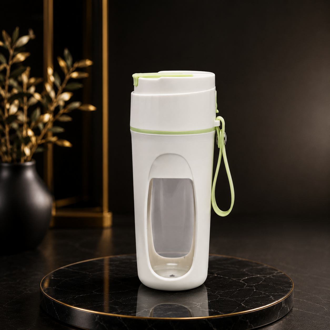 A white travel tumbler with a clear window and light green accents, including a wrist strap, displayed on a black marble round tray against a dark background.