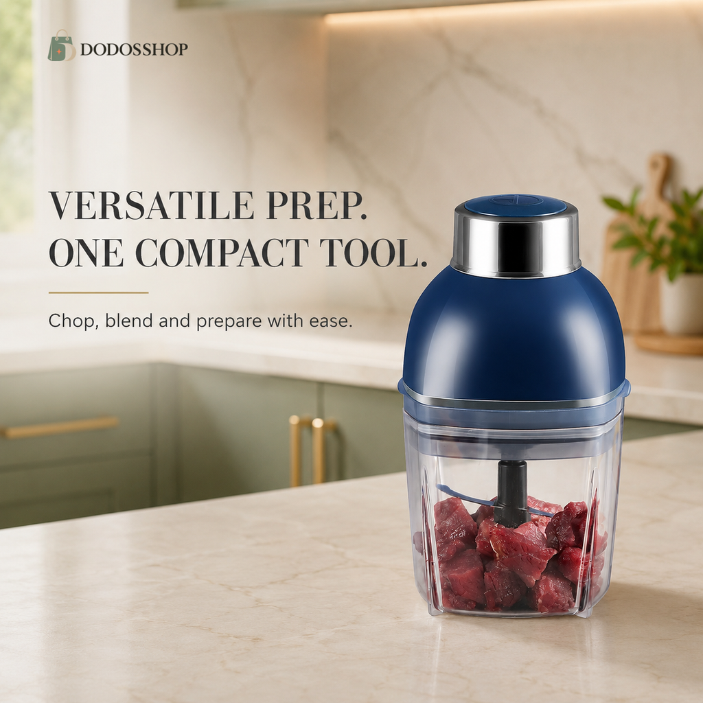 A compact electric food chopper with a dark blue body and clear container filled with red meat, set on a marble kitchen countertop with promotional text and the DODOSSHOP logo.