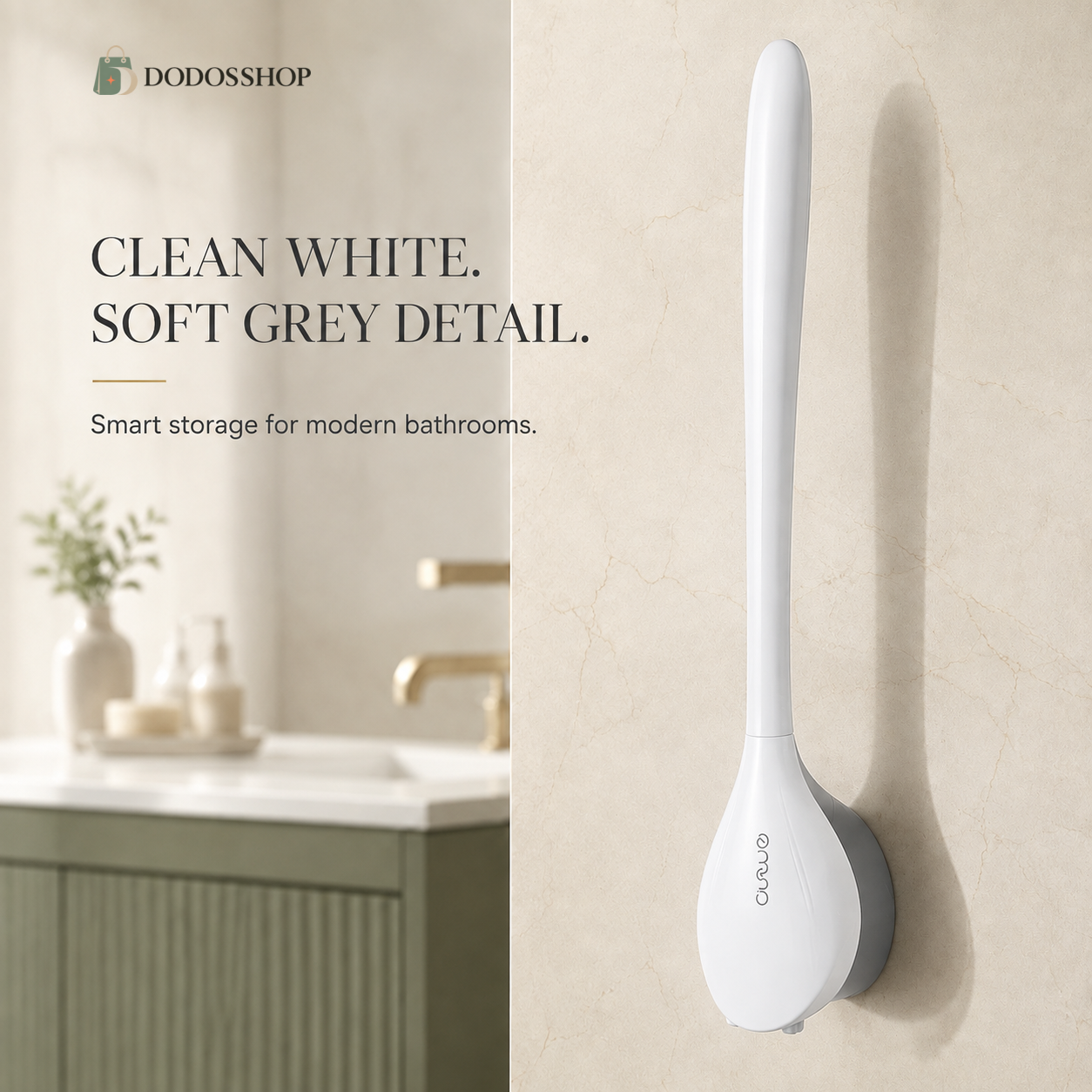 A wall-mounted bathroom cleaning brush in a clean white finish with a soft grey base, shown mounted on a beige marble-look wall. The left side features a split-screen lifestyle background of a bathroom vanity with text reading 'CLEAN WHITE.